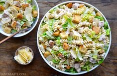 two bowls filled with pasta salad next to a bowl full of chicken and lettuce