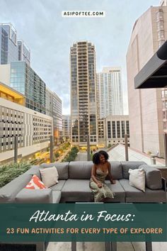 a woman sitting on top of a couch in front of tall buildings with the words atlanta focus