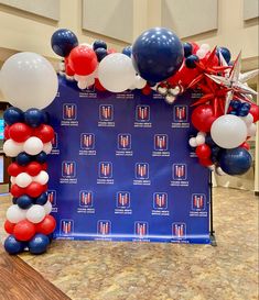 an american flag balloon arch with red, white and blue balloons