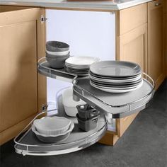 an open cabinet with plates and bowls in it