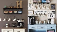 a coffee bar with cups and mugs hanging on the wall next to an old dresser