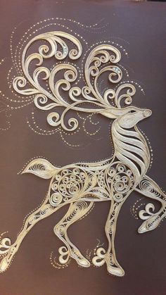 an intricately designed deer with swirls and curls on it's back side