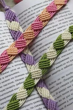 an open book with two braided bracelets on it