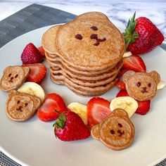 pancakes with strawberries, bananas and faces on them are arranged in the shape of hearts