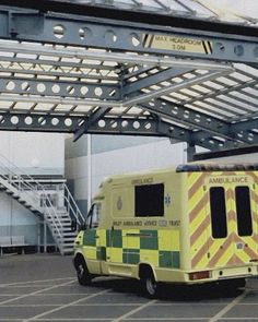 an ambulance is parked under a metal structure