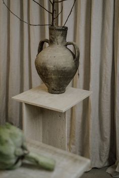 a vase sitting on top of a wooden table