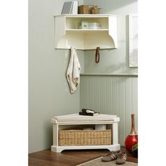 a white bench sitting next to a shelf with baskets on it