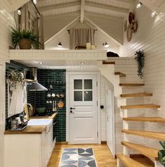 a kitchen and stairs in a tiny home