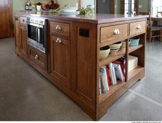 the kitchen island is open and has many items in it