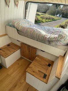 the interior of a camper with stairs leading up to it and a bed in the back