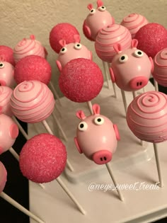 cake pops with pink frosting decorated as pigs