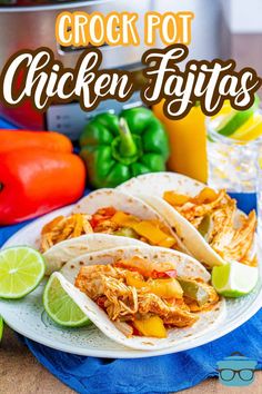 crock pot chicken fajitas on a white plate with limes and peppers