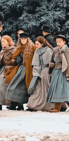 several people dressed in period clothing walking together