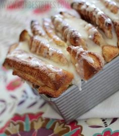 some kind of pastry with icing on top of it sitting on a tablecloth