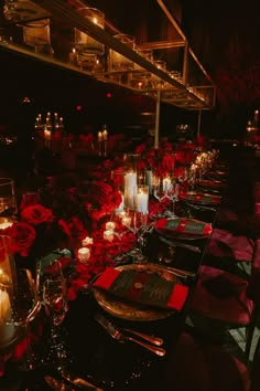 a long table with candles and flowers on it