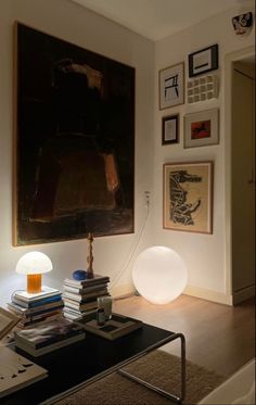 a living room filled with furniture and pictures on the wall above it's coffee table