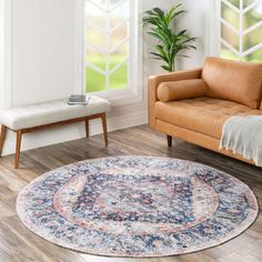 a living room with a couch, chair and rug