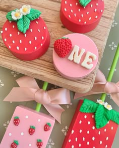 strawberry themed cupcakes with strawberries and numbers on them