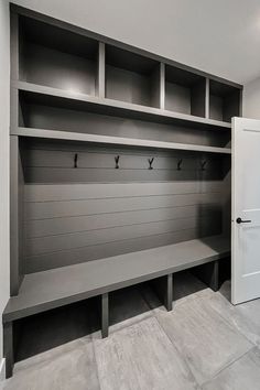 an empty bench in the middle of a room with built - in shelvings