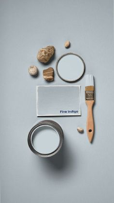 a paintbrush and some other items on a gray surface with the words fine interiore