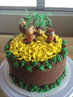 there is a cake decorated with monkeys and bananas