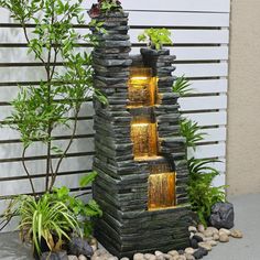 an outdoor water fountain with lights on it