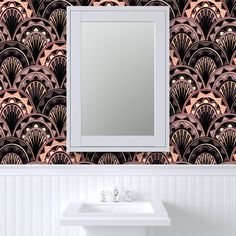 a bathroom sink under a mirror next to a wallpapered wall with an art deco design