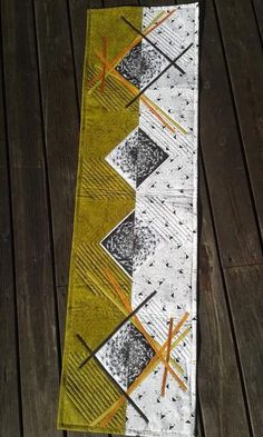 the table runner is made from an old piece of fabric and has been stitched together