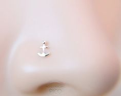 an earring with a small anchor on it