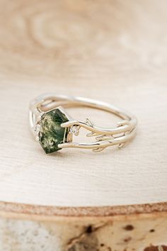 a green ring sitting on top of a wooden table