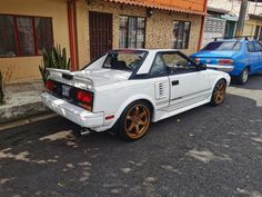 a white car parked in front of a building