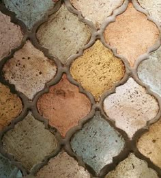 a close up view of a tile with different colors and patterns on it's surface