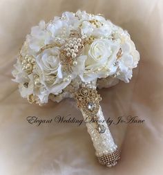 a bridal bouquet with white flowers and pearls