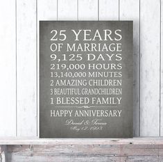 a sign that says 25 years of marriage in white lettering on a wooden shelf next to a fireplace