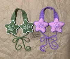 two crocheted purses with flowers on them, one is green and the other is purple