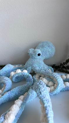 an octopus stuffed animal sitting on top of a table