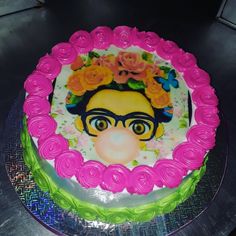 a cake with pink frosting and flowers on it