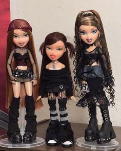 three dolls are standing next to each other