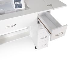 a white desk with drawers and a phone on it