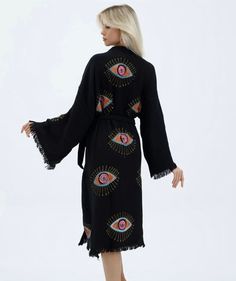 "Beautiful handmade black evil eye kimono robe, designed with cotton fabric, it flows as you move for a comfortable wear. Beach cover up, a kimono with black evil eye designs. All designs are made with the stone press technique. This is a lovely, good-quality kimono, with traditional breathable kimono sleeves.        A belt that ties around the waist. Great to wear around the house, on beaches, or to dress up with some jeans & a T-shirt, covering up on the beach with a swimsuit. They also make r Bohemian Black Long Robe, Bohemian Long Black Robe, Black Long Bohemian Robe, Long Black Bohemian Robe, Bohemian Black Robe With Kimono Sleeves, Black Bohemian Robe With Kimono Sleeves, Black Bohemian Kimono With Kimono Sleeves, Black Cotton Kimono For Festivals, Black Cotton Kimono For Summer