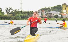 a group of people in kayaks paddling through the water with paddles on their backs