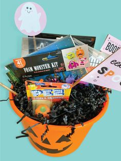 an orange bucket filled with halloween items