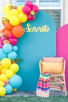 colorful balloons are hanging from the side of a blue sign that reads,'snora