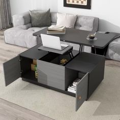 a living room with a couch, coffee table and laptop on top of the table