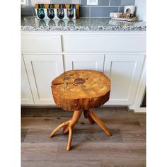 a wooden stool sitting on top of a kitchen floor