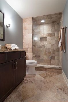 a bathroom with a toilet, shower and sink