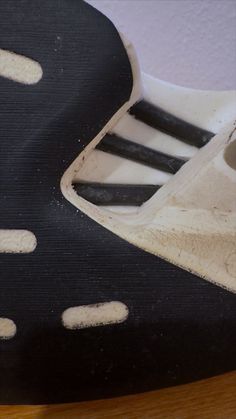 a close up view of the inside of a soccer shoe with white and black stripes