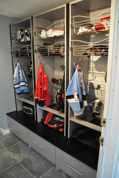 the lockers are full of sports gear and hats for baseball players to wear on their team's uniforms