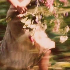 a blurry photo of a woman holding flowers