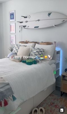 a bedroom with a surfboard mounted to the wall above it's headboard